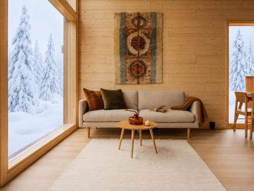 a living room with a couch and a table at Ainur Villas in Saariselka