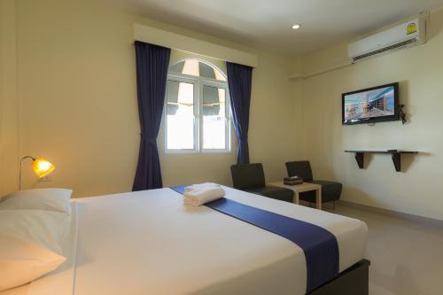 Un pat sau paturi într-o cameră la Zing Resort & Spa