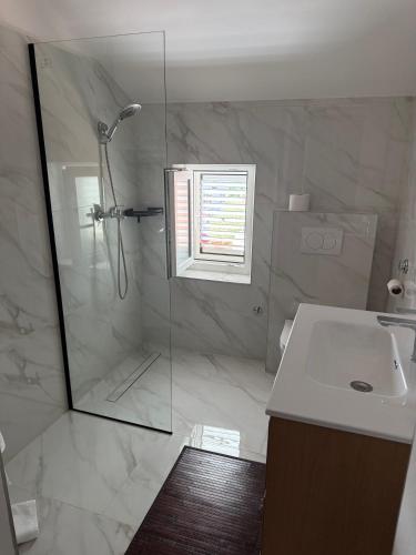 a bathroom with a shower and a sink at Apartments Cunski in Čunski