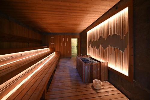 a row of benches in a building with lights at Hotel Zochova Chata - Adult friendly in Modra
