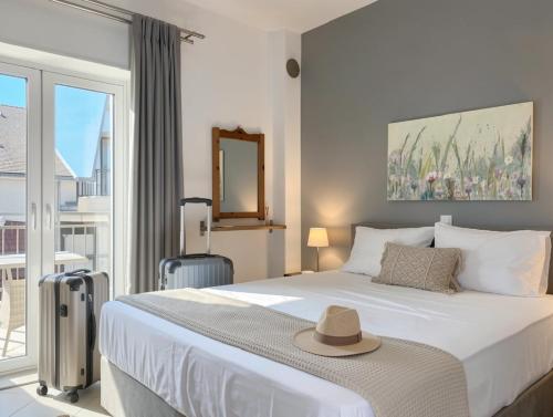 a bedroom with a bed with a hat on it at Thalassa Kai almira studios in Sarti