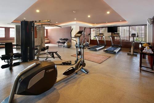 a gym with treadmills and exercise equipment in a room at The Magani Hotel and Spa in Legian