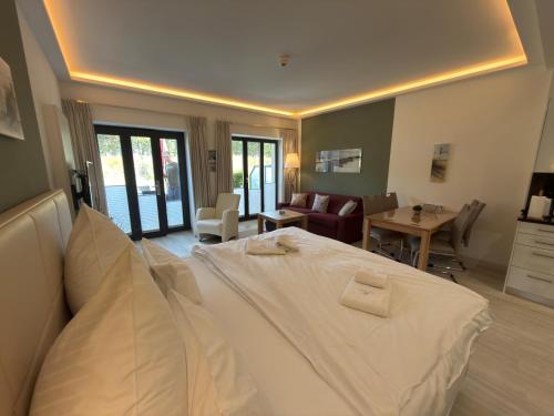 a bedroom with a bed and a living room at Strand FeWo Rügen Baltic Sea in Binz