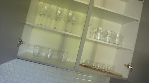 a cabinet with wine glasses on it in a bathroom at Weitblick am Rammenfeld in Schönecken