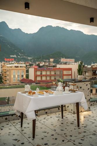 a table with plates of food on top of a building at Perfectstayz Premium Mahadev Regency in Katra