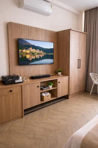 a living room with a television on a wall at Vintage Bak Holidays in Vythiri