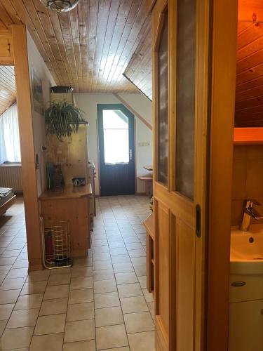 a kitchen with a door and a tile floor at Bohinj Nook Apartment in Bohinj