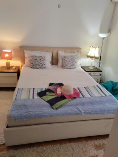 a bedroom with a bed with two towels on it at Apartman Angela in Budva