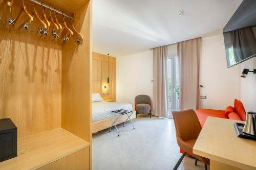 a hotel room with a bed and a living room at Istedda Boutique Hotel in Villasimius