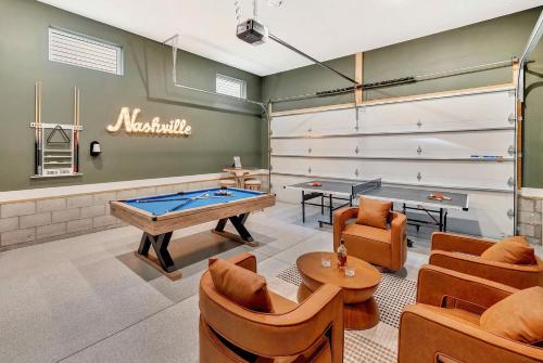 a room with a pool table and ping pong balls at Rooftop Deck & Shuffleboard BBQ Near Downtown in Nashville