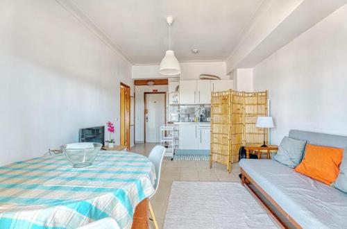 a living room with a bed and a couch at Only 10 min from Lisbon city centre, 15 min driving from the beaches! in Almada
