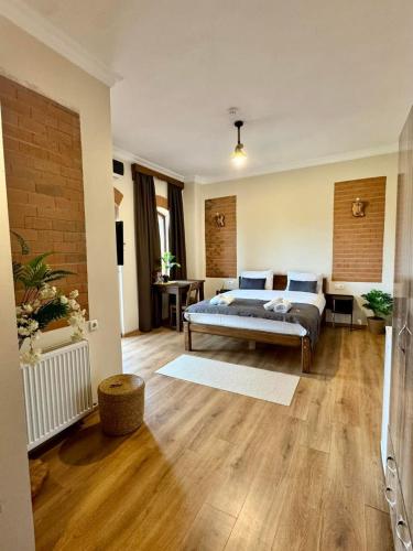 a bedroom with a bed and a living room at Hotel Anari in Sik't'arva
