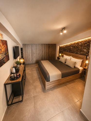 a bedroom with a large bed and a table at Airport Sea View - Studio - 15 mins from Athens Airport in Artemida