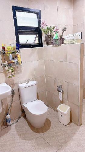 a bathroom with a toilet and a sink at Palm Oasis in Nathon Bay