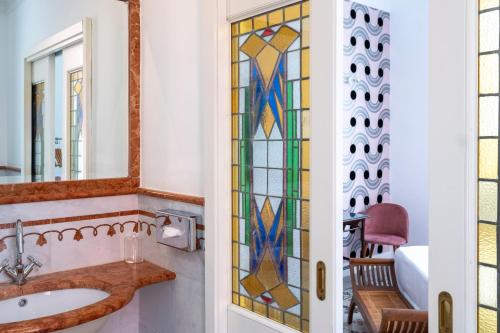 a bathroom with a sink and a mirror at Hotel Emona Aquaeductus in Rome