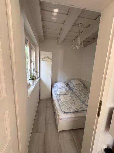 a small bedroom with a bed in a room at Funny Füred in Balatonfüred