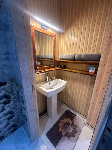 a bathroom with a sink and a mirror at Liana Guest House Ella in Ella