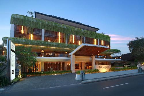 a large building with ivy on the side of it at The Magani Hotel and Spa in Legian