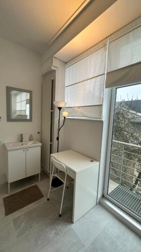a room with a desk and a window at B@Home Apartments in Sanem
