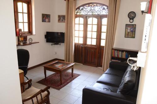 a living room with a couch and a table at Gondolas Home Stay in Ragama