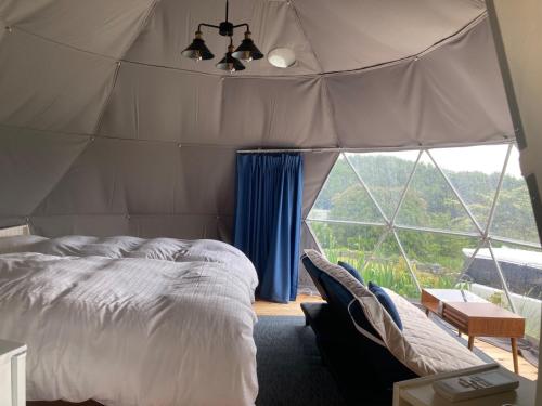 a bedroom with a bed and a large window at Base Camp Spring - Vacation STAY 35488v in Shibukawa