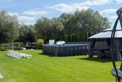 a yard with chairs and a frisbee at Albian Apartamenty in Jantar