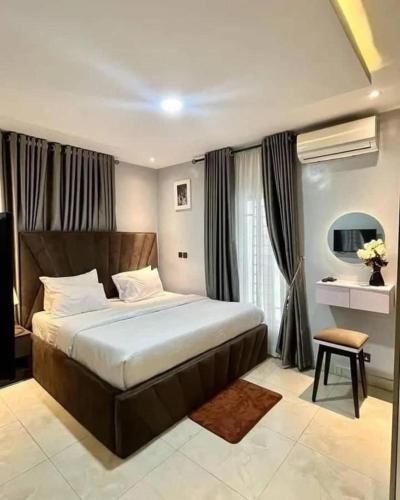a bedroom with a large bed in front of a window at Rivona Hotels & Suites in Uyo