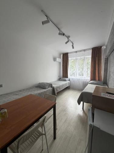 a living room with a couch and a table at 7 Nebo in Almaty
