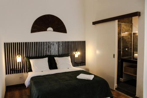a bedroom with a large bed with a black headboard at Résidence Marotia in Antananarivo