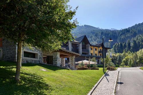 a large house on the side of a road at Blu Hotel Acquaseria in Ponte di Legno