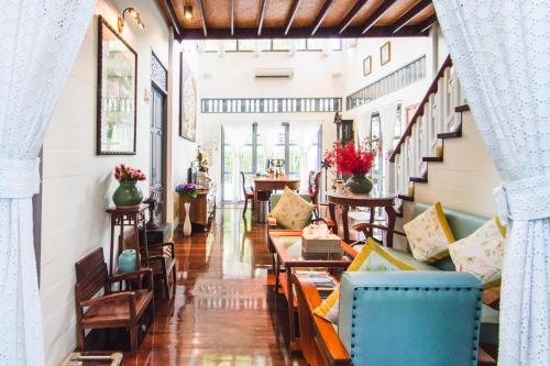a living room with couches and tables at Baan Noppawong in Bangkok