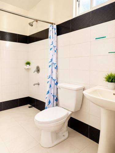 a bathroom with a toilet and a sink at Buena's Haven Travelodge in El Nido