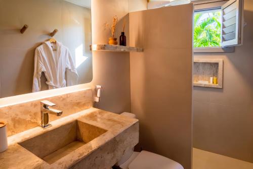 a bathroom with a sink and a toilet at Pousada Vina in Jericoacoara