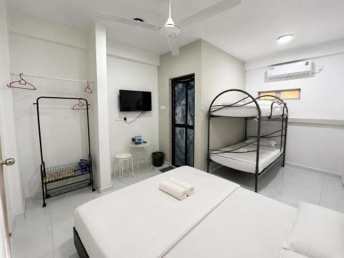a bedroom with two bunk beds and a tv at CasaView Beach in Paka