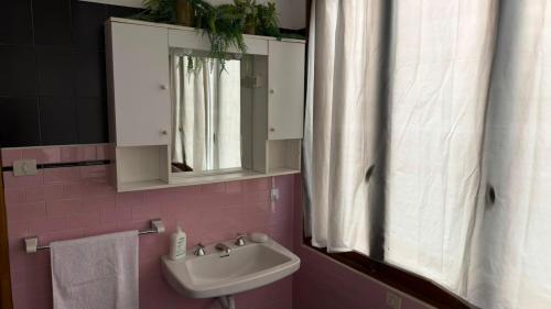 a bathroom with a sink and a mirror at Etoile Affittacamere in Saint Vincent