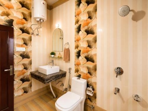 a bathroom with a toilet and a sink at Whispering Meadows Luxury 3BHK Villa in Shimla