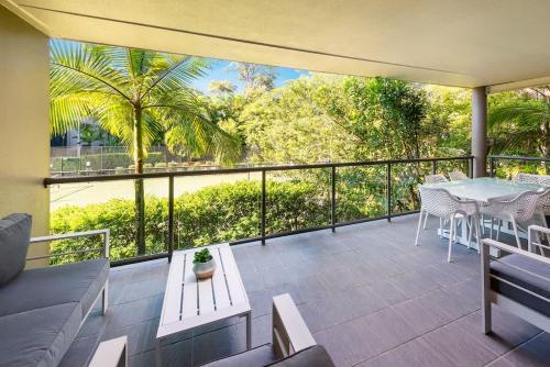 a balcony with a table and chairs and a view at Azure Beach Retreat 2 in Rainbow Beach