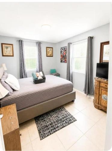 a bedroom with a large bed and a window at Perfect Family Group Getaway in West Palm Beach