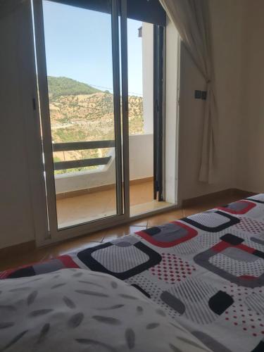 a bedroom with a bed and a large window at Villa The View in Tétouan