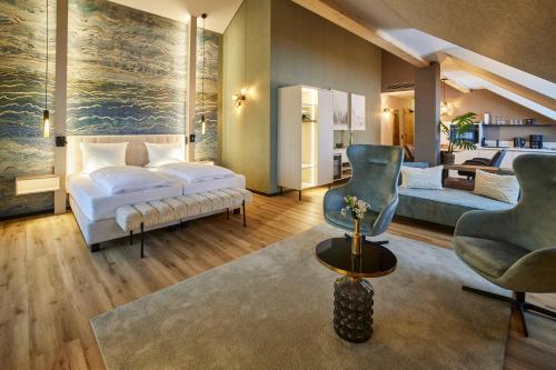 a bedroom with a bed and a living room at Weingut und Gästehaus Apel in Nittel