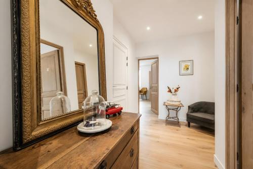 a mirror on top of a dresser in a living room at Le Bellevue in Excénevex
