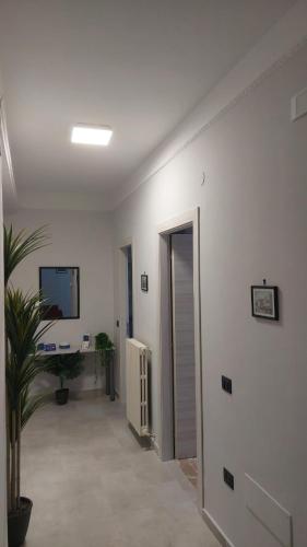 a room with a hallway with a desk and a television at A Casa di Nonna Lidia in Crotone