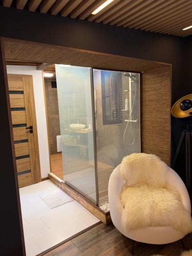 a white chair in a room with a shower at Villa INDIANA Devin in Devin