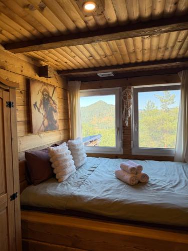 a bed in a log cabin with two teddy bears on it at Villa INDIANA Devin in Devin