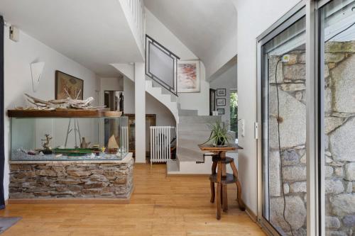 a stone fireplace in a living room with a stone wall at Maison Bringwiller Plage 200m in Trégastel