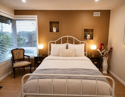 a bedroom with a bed and a chair at Spacious Frankston Retreat in Frankston