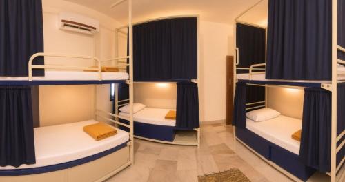a room with bunk beds in a hostel at Kattil Madurai in Madurai