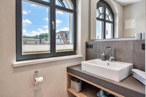 a bathroom with a sink and a window at Ferienwohnung Sandbank in der Villa Martha Binz in Binz