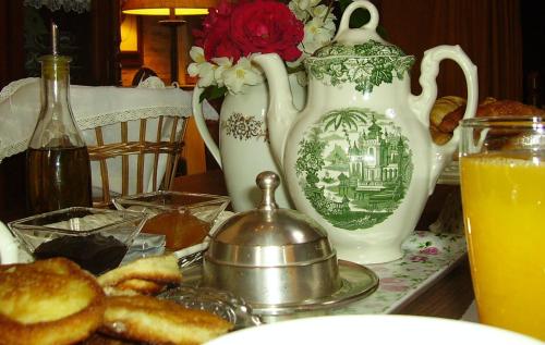 a table topped with a plate of food and a cup of coffee at Hotel Boutique Condes Fúcares in Almadén