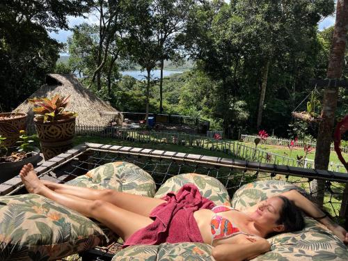 a woman laying on a couch on a patio at TerrAmor Ecoliving in Alter do Chao